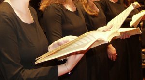 A close up of a person holding a music folio